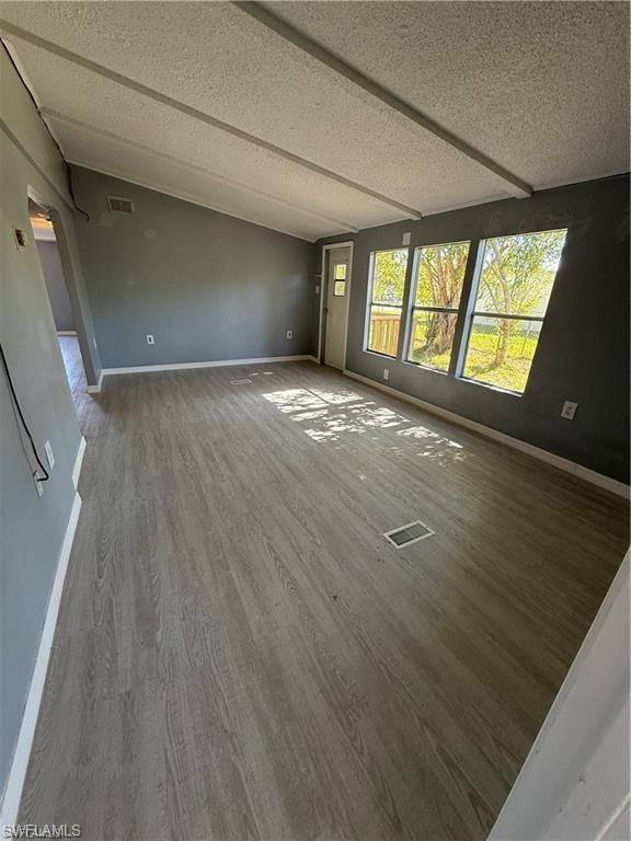 21 Ocho Rios Naples, FL 34114 - Photo 2 of 5 wooden floor in an empty room with a window