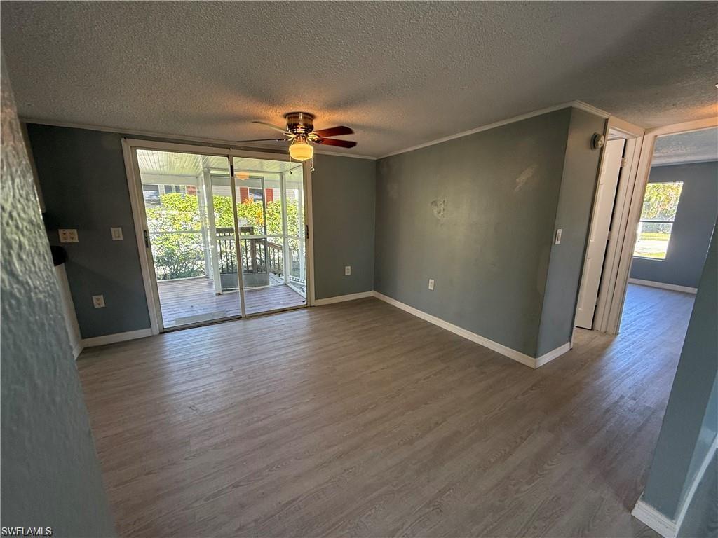 21 Ocho Rios Naples, FL 34114 - Photo 3 of 5 an empty room with wooden floor and windows
