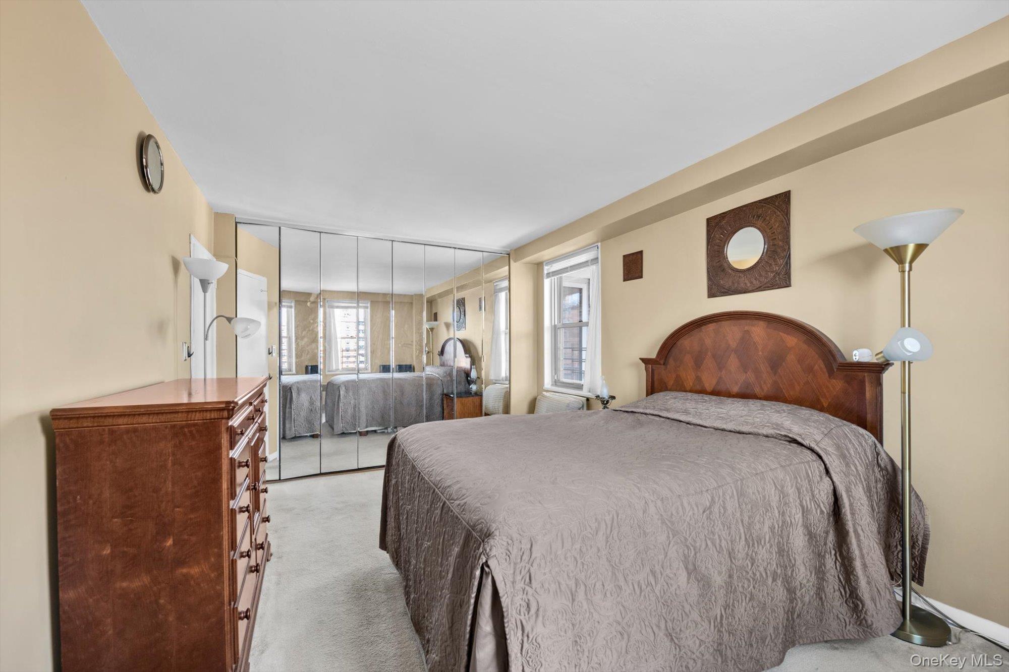 61-15 97th Street, Unit 12A Queens, NY 11374 - Photo 13 of 25 a bedroom with a bed and a dresser