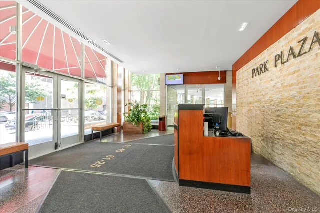 a living room with patio furniture and a floor to ceiling window