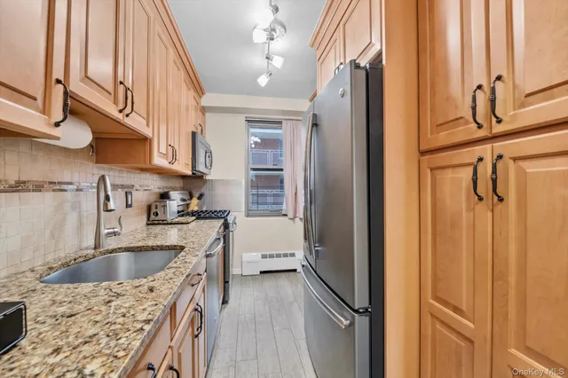a kitchen with a refrigerator a sink and cabinets