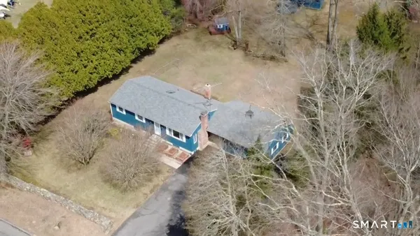 a view of a dry yard with wooden fence