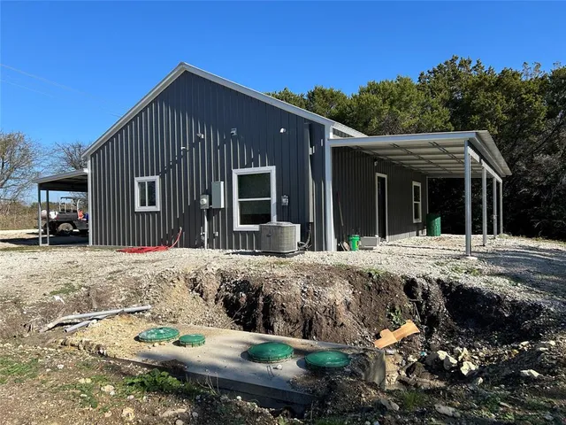 a view of a house with a backyard