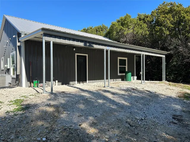 a house with tree in front of it