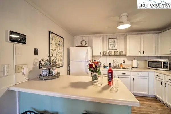 a view of a kitchen with sink and microwave