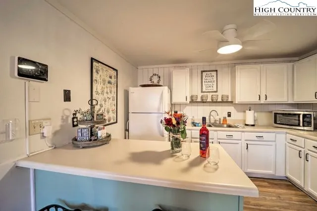 a view of a kitchen with sink and microwave