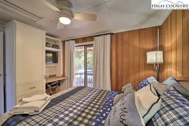 a bedroom with a large bed and a window