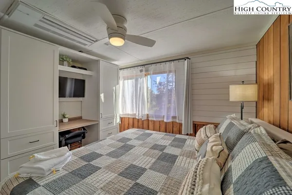 a bedroom with a bed and lamp