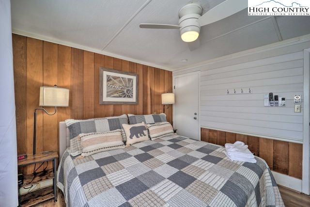 220 Charter Hills Road, Unit B2 Beech Mountain, NC 28604 - Photo 22 of 37 a bedroom with a bed and lamp