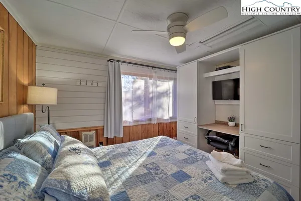 a bedroom with a bed and a lamp on table