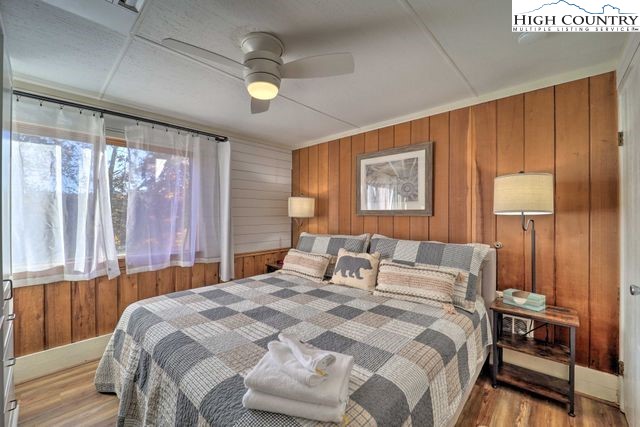 220 Charter Hills Road, Unit B2 Beech Mountain, NC 28604 - Photo 25 of 37 a bedroom with a bed and a lamp on table