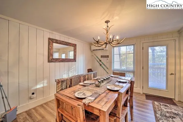 a view of a dining room with furniture wooden floor and chandelier