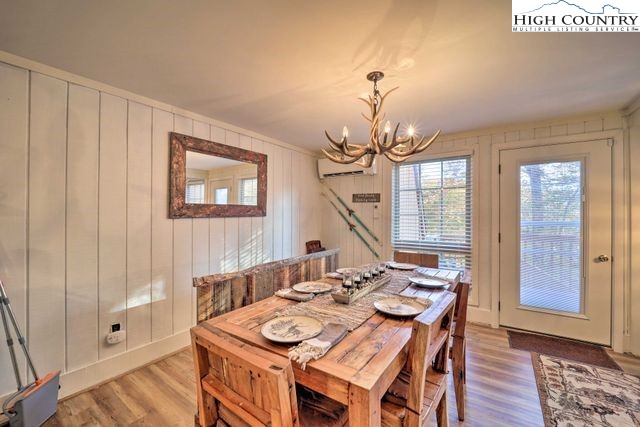 220 Charter Hills Road, Unit B2 Beech Mountain, NC 28604 - Photo 6 of 37 a view of a dining room with furniture wooden floor and chandelier