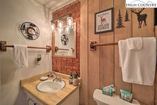 a bathroom with a sink mirror vanity and toilet