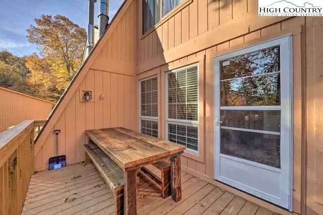 a balcony with a table and chairs