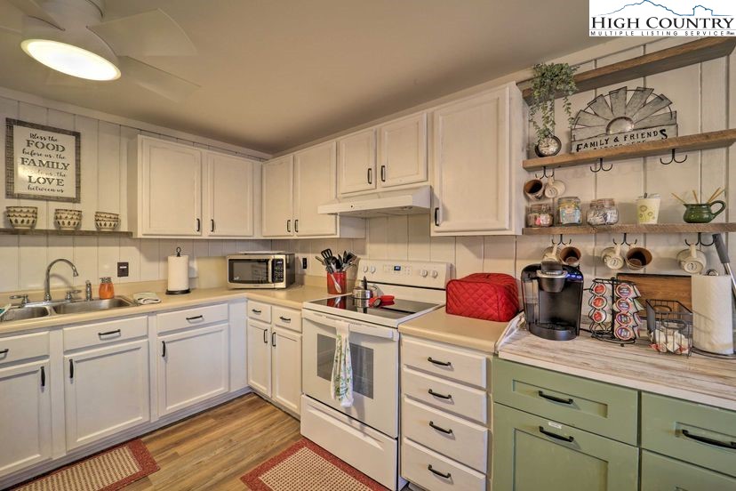 220 Charter Hills Road, Unit B2 Beech Mountain, NC 28604 - Photo 10 of 37 a kitchen with white cabinets and white appliances