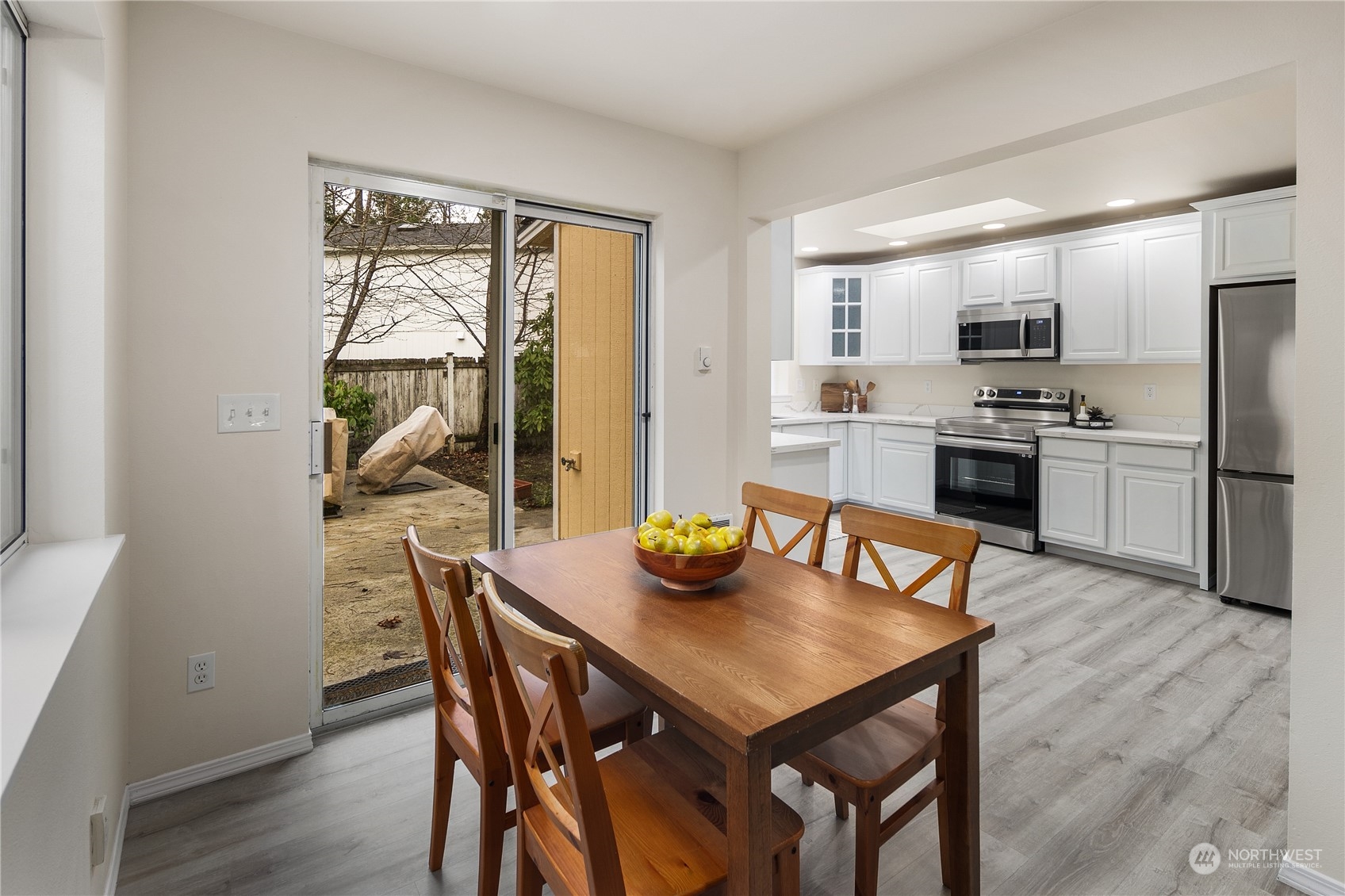 26318 127th Avenue Southeast Kent, WA 98030 - Photo 13 of 40 a view of a dining room with furniture window and wooden floor