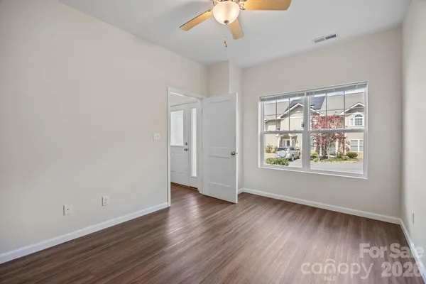 a view of an empty room with wooden floor
