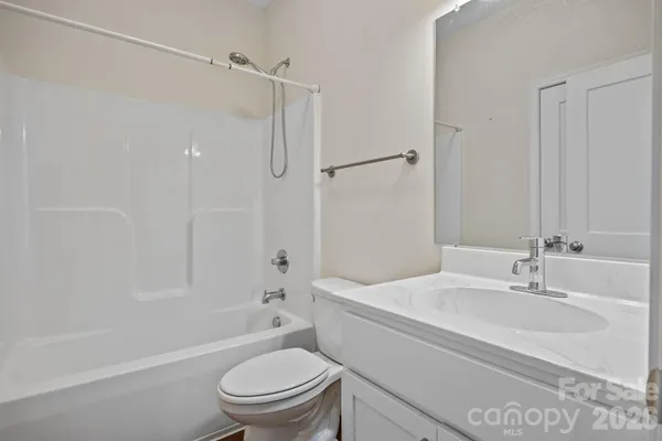 a bathroom with a sink toilet vanity and shower