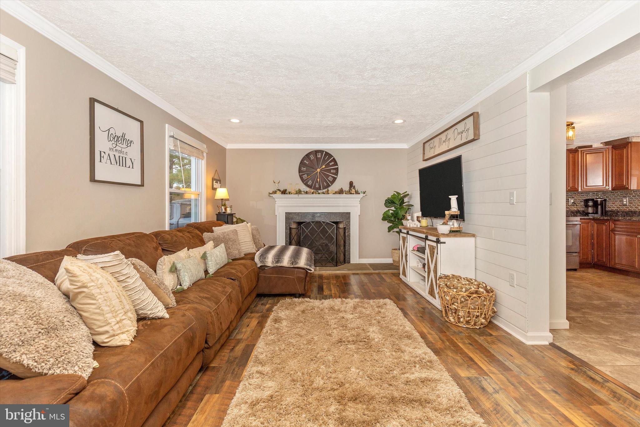 47 Pheasant Ridge Road Hanover, PA 17331 - Photo 5 of 35 a living room with furniture a fireplace and a flat screen tv
