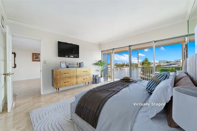 a bedroom with a bed and large windows