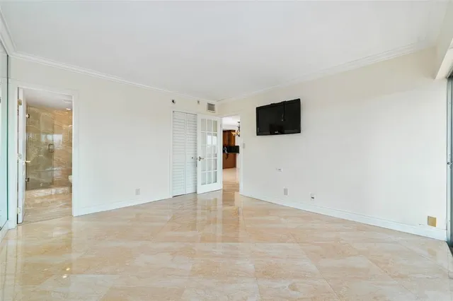 a view of a livingroom with an empty space and a window