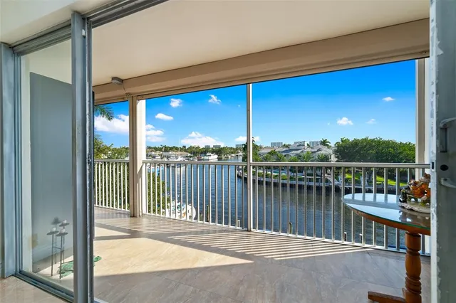 a view of a balcony with couches and wooden floor