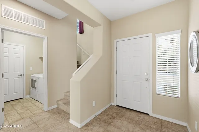 a view of a livingroom with an empty space and a window