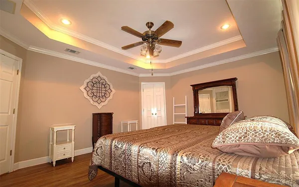 a bedroom with a bed and a chandelier