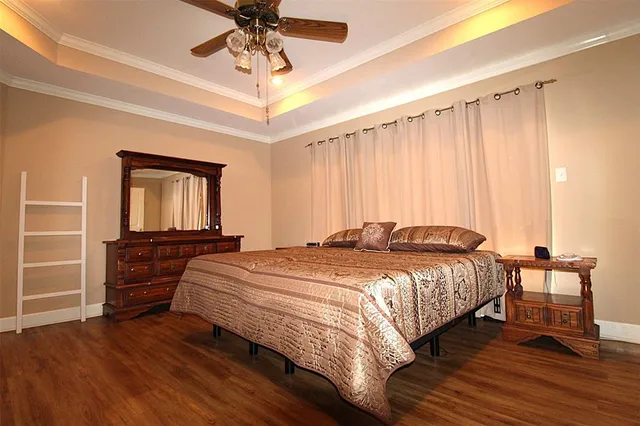 a bedroom with a bed and a chandelier