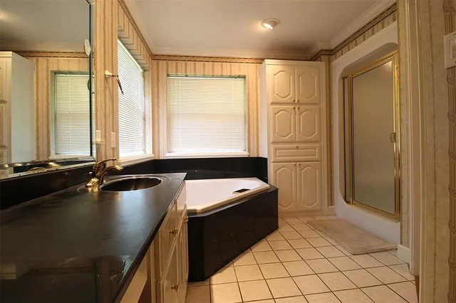 a room with a table chairs and chandelier