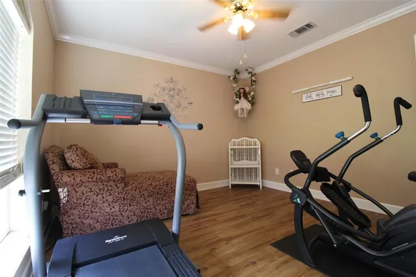 a view of a room with furniture and wooden floor