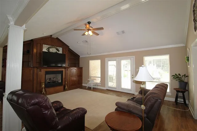 a living room with furniture a fireplace and a flat screen tv