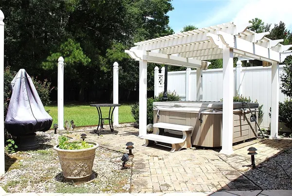 a view of a patio with a dining table and chairs with wooden floor