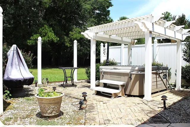 a view of a patio with a dining table and chairs with wooden floor