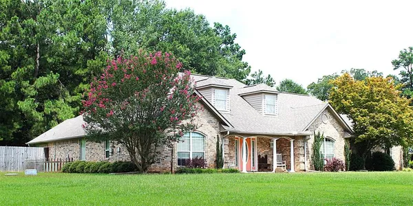 a view of house with a yard