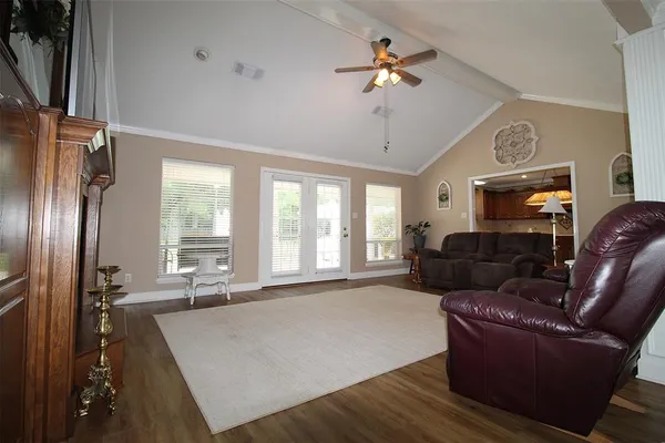 a living room with furniture and a chandelier