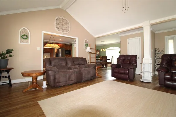 a living room with furniture and a chandelier