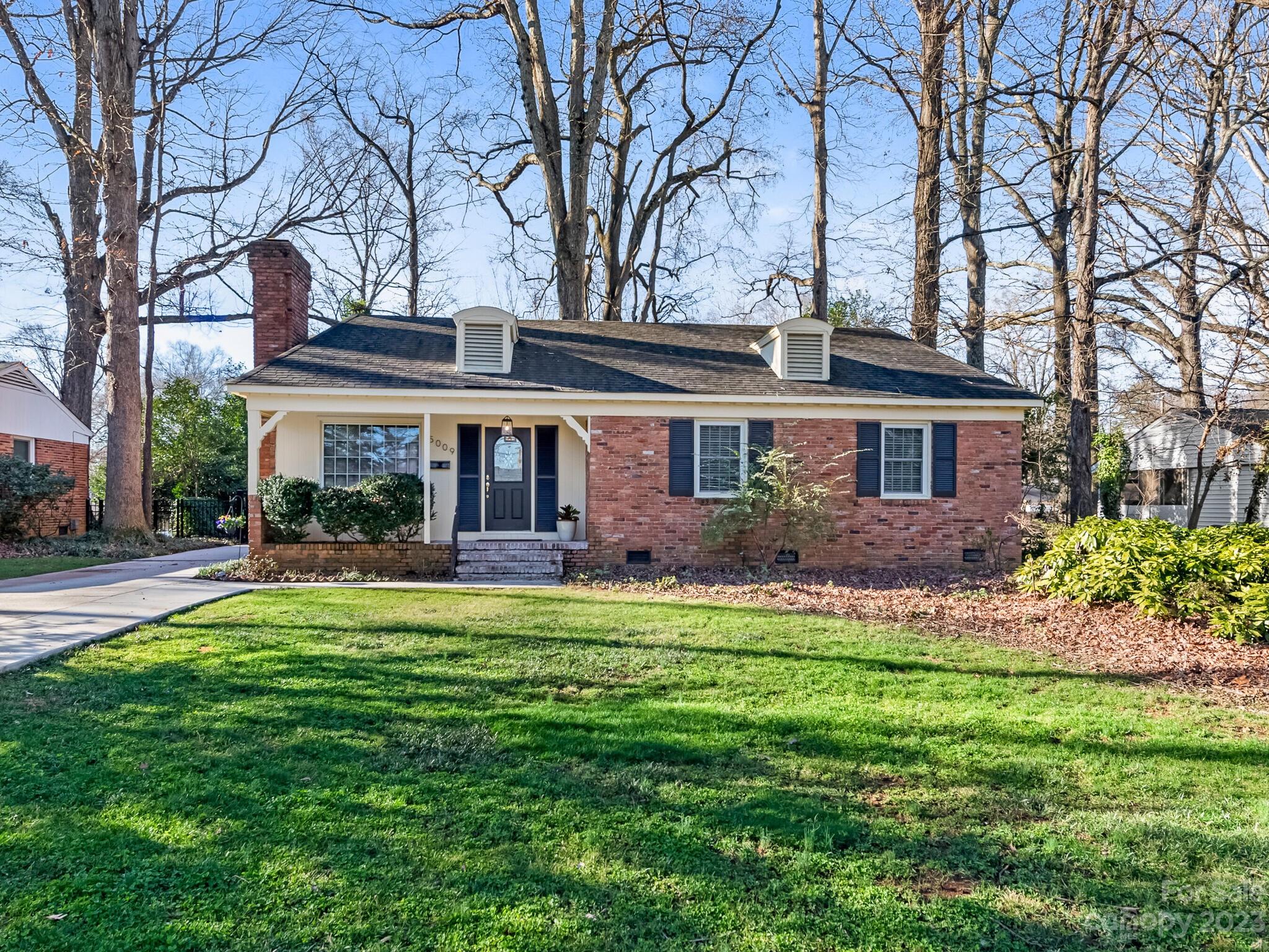 5009 Milford Road Charlotte, NC 28210 - Photo 1 of 19 a front view of a house with a garden and trees