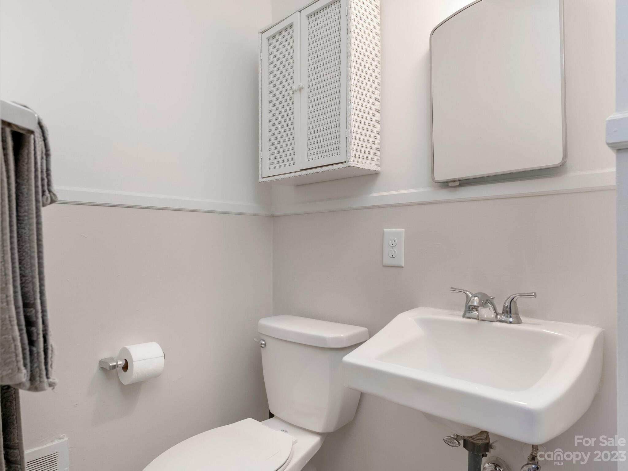5009 Milford Road Charlotte, NC 28210 - Photo 11 of 19 a bathroom with a sink a toilet and a mirror