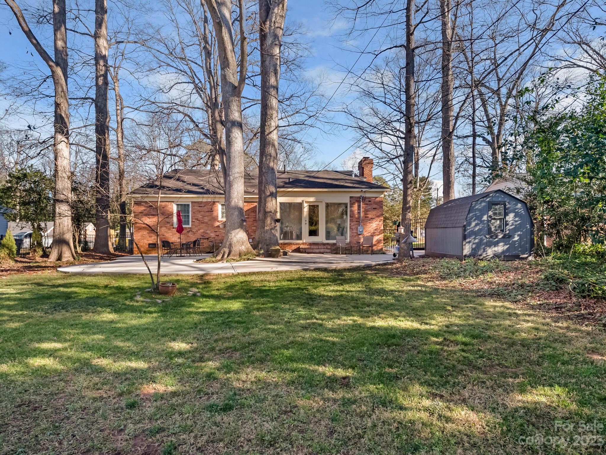 5009 Milford Road Charlotte, NC 28210 - Photo 17 of 19 a front view of a house with a garden and trees