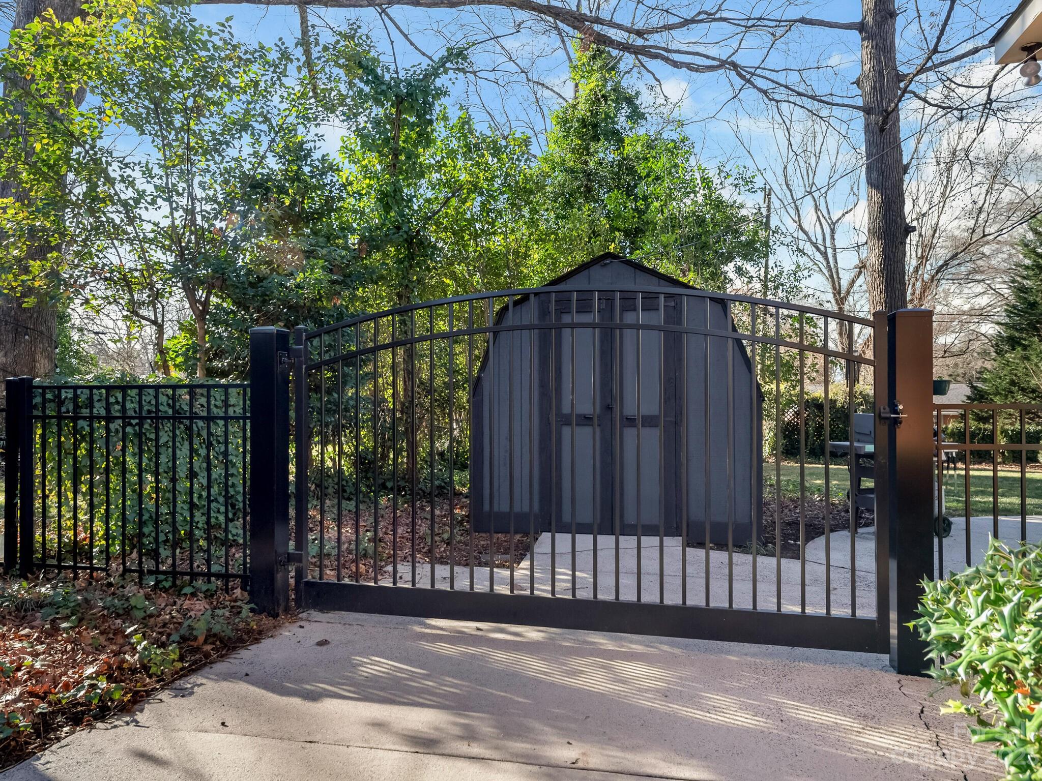 5009 Milford Road Charlotte, NC 28210 - Photo 19 of 19 a view of a wooden fence under a large tree
