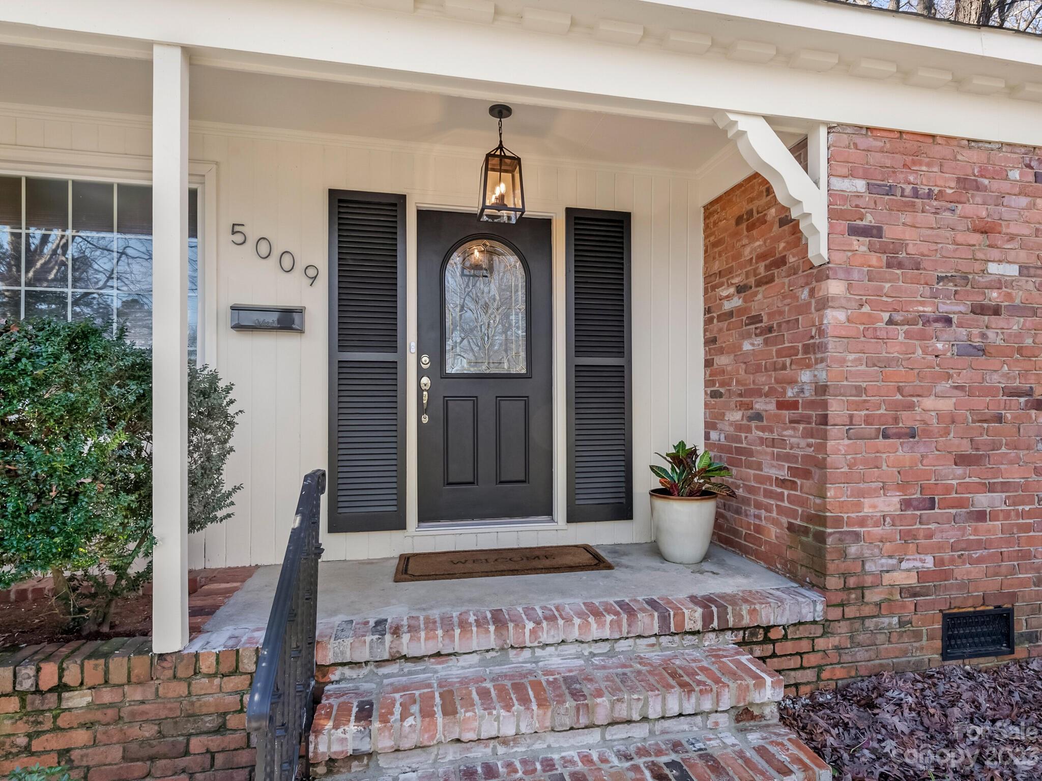 5009 Milford Road Charlotte, NC 28210 - Photo 2 of 19 a front view of a house with potted plants