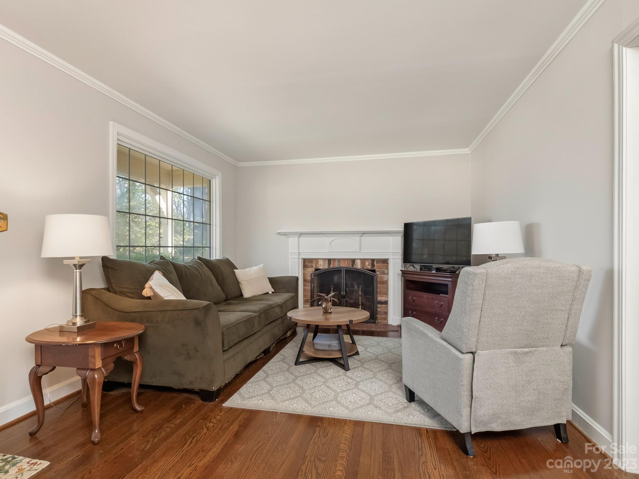 5009 Milford Road Charlotte, NC 28210 - Photo 4 of 19 a living room with furniture and a flat screen tv