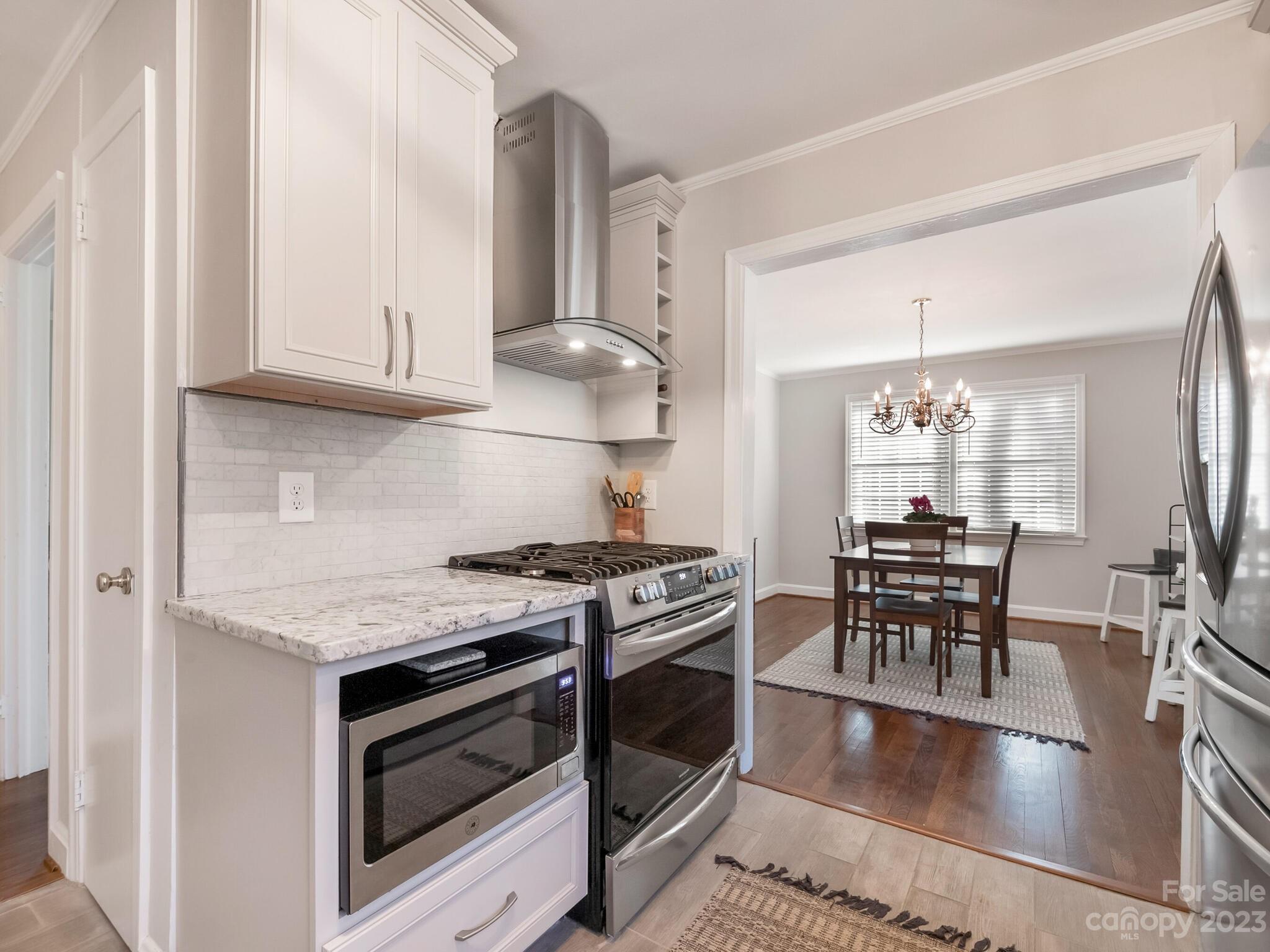 5009 Milford Road Charlotte, NC 28210 - Photo 6 of 19 a kitchen with stainless steel appliances granite countertop a stove a sink and a refrigerator