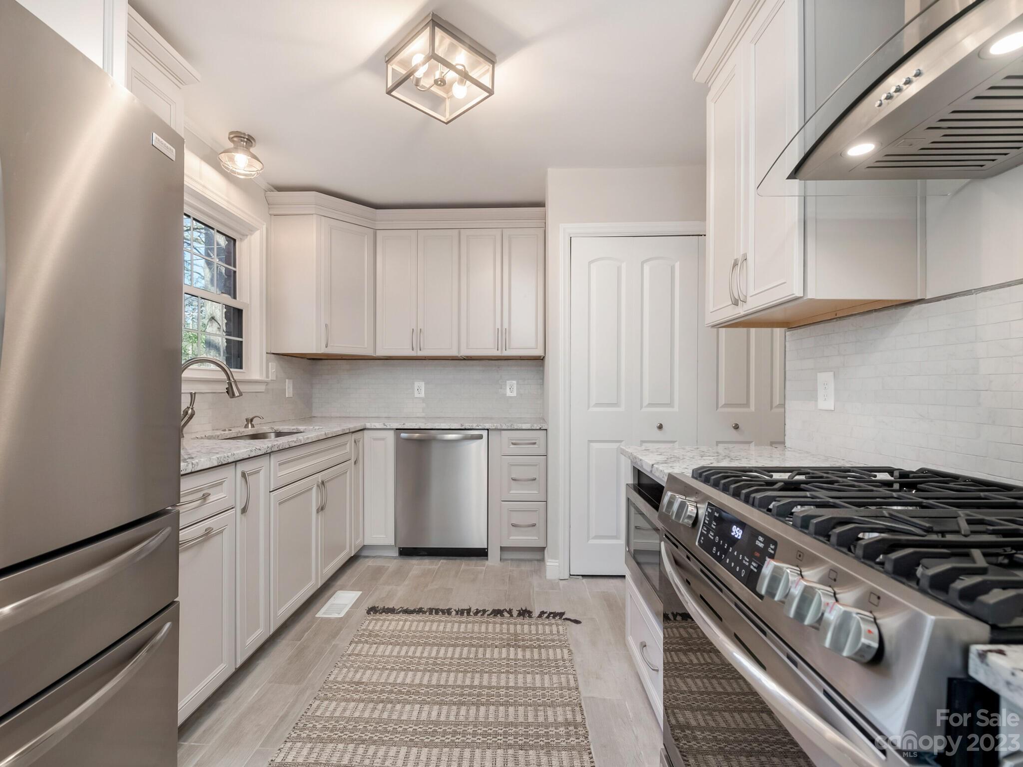 5009 Milford Road Charlotte, NC 28210 - Photo 7 of 19 a kitchen with granite countertop a stove and a sink
