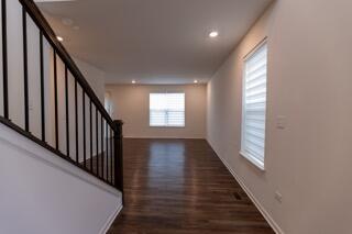 1792 East 110th Lane Crown Point, IN 46307 - Photo 2 of 17 a view of a hallway with wooden floor and staircase