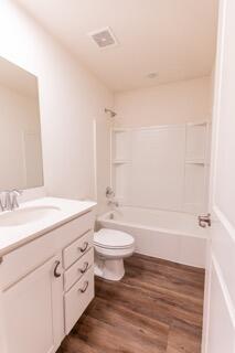 1792 East 110th Lane Crown Point, IN 46307 - Photo 9 of 17 a bathroom with a granite countertop sink a toilet and shower