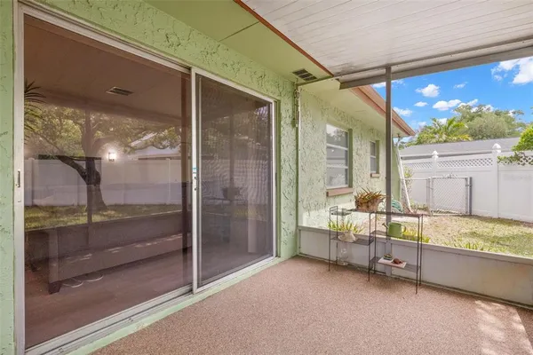 a backyard of a house with table and chairs
