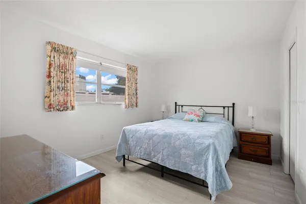 a bedroom with a bed and a large window